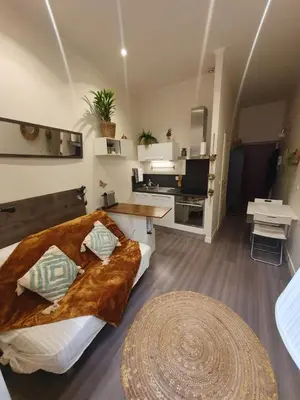 a bedroom with a bed and a table in a room at Studio au cœur du vieux Nice in Nice