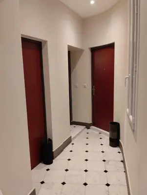 a hallway with two doors and a tiled floor at Studio au cœur du vieux Nice in Nice
