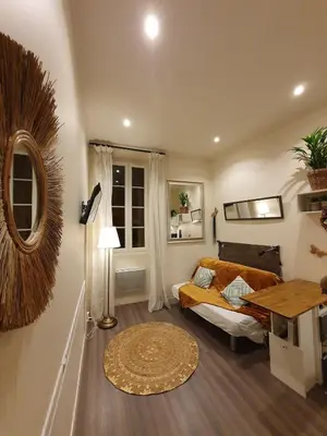 a living room with a couch and a table at Studio au cœur du vieux Nice in Nice