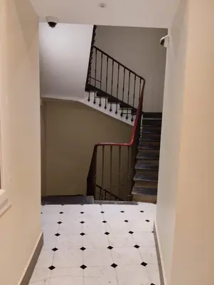 a hallway with a staircase and a tiled floor at Studio au cœur du vieux Nice in Nice
