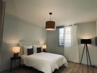 a bedroom with a white bed and a window at Appartement avec Terrasse - Palais Historique à Nice in Nice