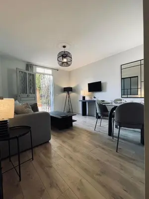 a living room with a couch and a table at Appartement avec Terrasse - Palais Historique à Nice in Nice