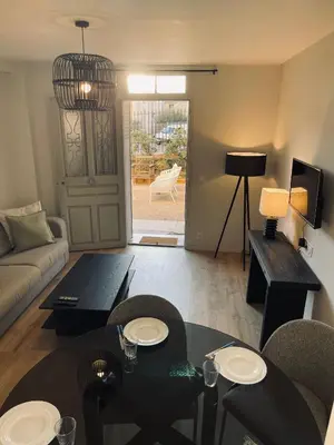 a living room with a couch and a table at Appartement avec Terrasse - Palais Historique à Nice in Nice