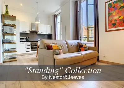 a living room with a couch and a kitchen at Nestor&Jeeves - COTE JARDIN - Central - Close sea in Nice