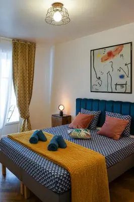 a bedroom with a bed with two blue towels on it at Riviera Prom 4 Pers Vista Mare in Nice