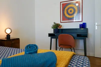 a bedroom with a desk and a bed and a chair at Riviera Prom 4 Pers Vista Mare in Nice