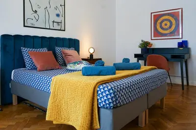 a bedroom with a blue bed with a yellow blanket at Riviera Prom 4 Pers Vista Mare in Nice
