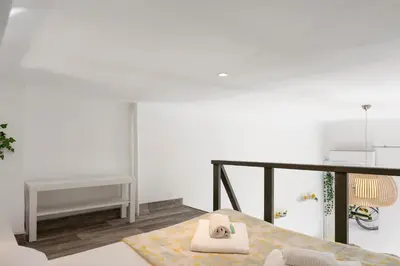a white room with a bed and a table at Studio Jaune FSHH in Nice