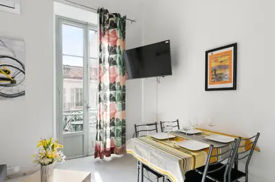 a dining room with a table and a window at Studio Jaune FSHH in Nice