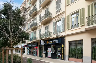 a store on a street in front of a building at Studio Jaune FSHH in Nice