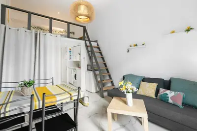 a living room with a couch and a table at Studio Jaune FSHH in Nice