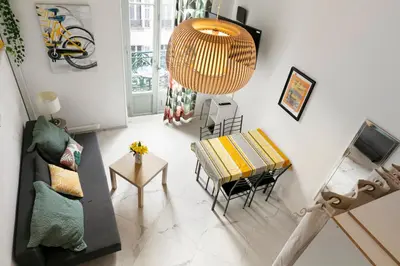 a living room with a couch and a table at Studio Jaune FSHH in Nice