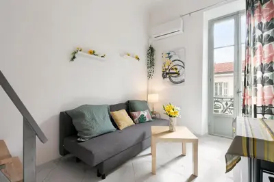a living room with a couch and a window at Studio Jaune FSHH in Nice