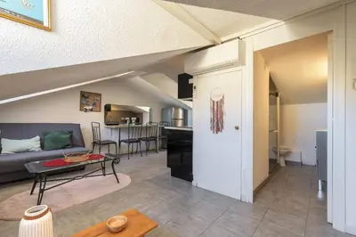 a living room with a couch and a table at Perchoir dans la vieille ville in Nice