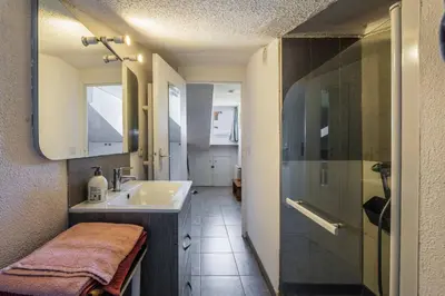 a bathroom with a sink and a shower at Perchoir dans la vieille ville in Nice