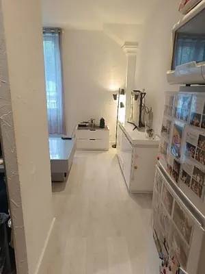 a white room with a hallway with a sink and a desk at Appart in Nice