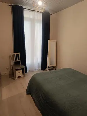 a bedroom with a bed and a chair and a window at Appart in Nice