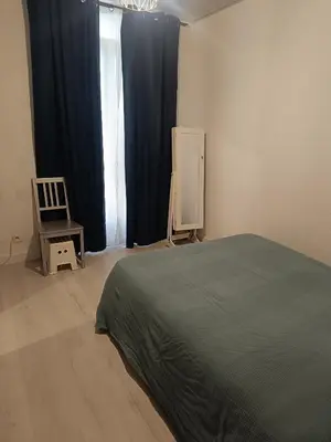 a bedroom with a bed and a chair and a window at Appart in Nice