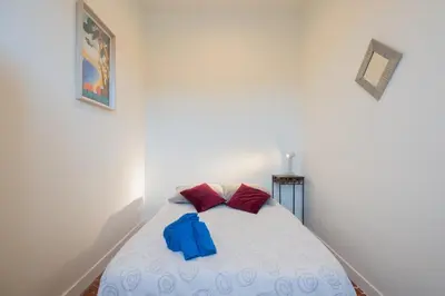 a bedroom with a bed and a dresser and a window at Nice - Beautiful bright apartment - 10 min beach in Nice