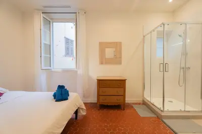 a bedroom with a white bed with red pillows at Nice - Beautiful bright apartment - 10 min beach in Nice