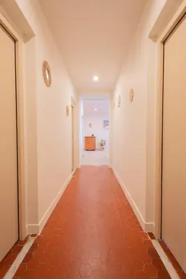 a kitchen with an orange wall and an oven at Nice - Beautiful bright apartment - 10 min beach in Nice