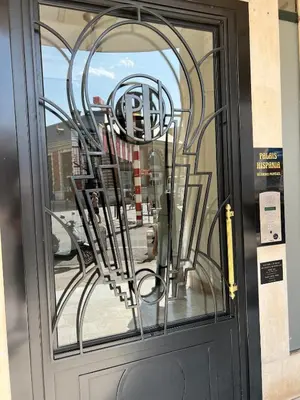 a glass door with a metal sculpture on it at T2 centre ville de Nice face de la gare routière Nice ville in Nice