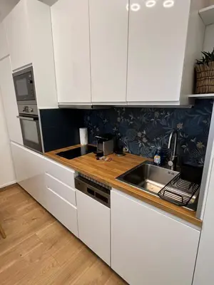 a kitchen with white cabinets and a sink at T2 centre ville de Nice face de la gare routière Nice ville in Nice