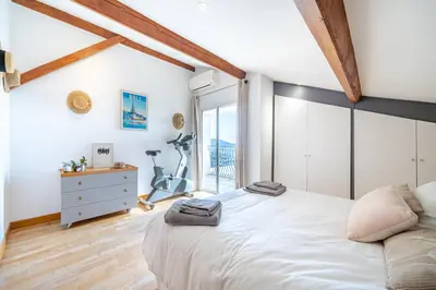 a bedroom with a large white bed and a window at Villa de prestige Vue mer panoramique Piscine Climatisation in Nice