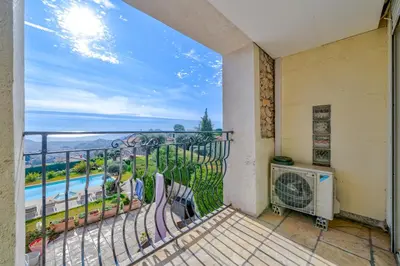 a balcony with a view of a pool at Villa de prestige Vue mer panoramique Piscine Climatisation in Nice