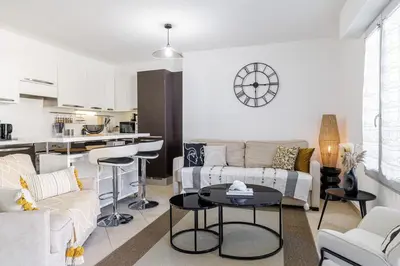 a living room with a couch and a table at Nice Luxury in Nice