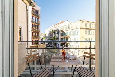 a table on a balcony with a view of a city at Nice Luxury in Nice