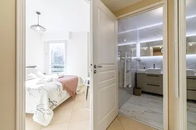 a bedroom with a bed and a bathroom with a sink at Nice Luxury in Nice