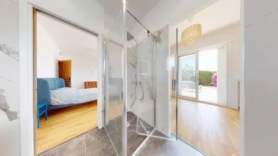 a glass shower in a room with a bedroom at Villa Grenouillere - Vue Mer - Fitness - Sauna in Cagnes-sur-Mer