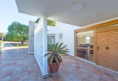 a house with a potted plant on a patio at Villa Grenouillere - Vue Mer - Fitness - Sauna in Cagnes-sur-Mer