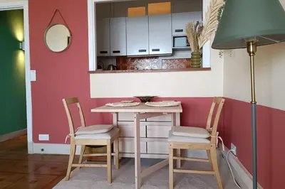a kitchen with a table and two chairs at Charming T1 with terrace and sea view in Nice
