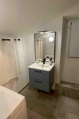 a white bathroom with a sink and a mirror at Charmant studio Vieux Nice in Nice