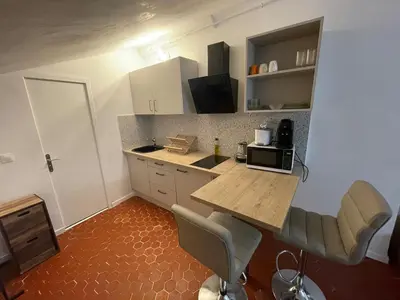 a kitchen with a table and chairs in a room at Charmant studio Vieux Nice in Nice