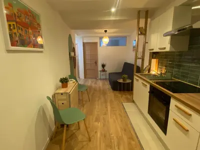 a kitchen and living room with a table and chairs at Cosy Appartement Vieux Nice in Nice