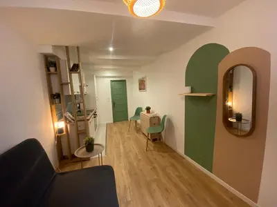 a living room with a couch and a mirror at Cosy Appartement Vieux Nice in Nice