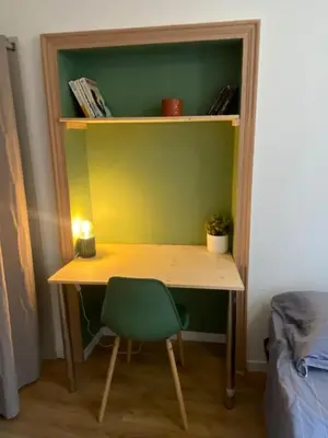 a desk with a green chair in a room at Cosy Appartement Vieux Nice in Nice