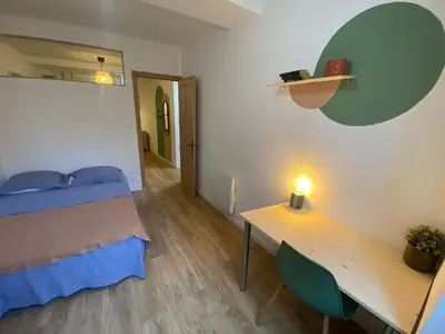 a bedroom with a bed and a table with a lamp at Cosy Appartement Vieux Nice in Nice