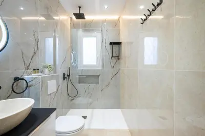 a bathroom with a shower and a sink and a toilet at Bleu Rivage - Magnifique 2P au Port de Nice - 1 chambre et 1 Mezzanine in Nice