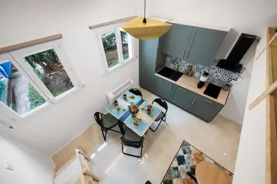 an overhead view of a dining room and kitchen in a tiny house at Bleu Rivage - Magnifique 2P au Port de Nice - 1 chambre et 1 Mezzanine in Nice