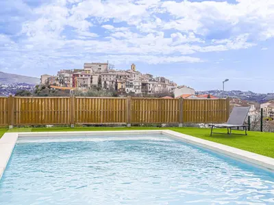 a swimming pool in a yard with a building in the background at Holiday Home Le Mas de Gattières by Interhome in Gattières