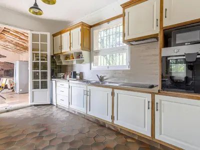a kitchen with white cabinets and a window at Holiday Home Le Mas de Gattières by Interhome in Gattières