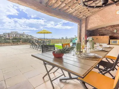 a wooden table and chairs on a patio at Holiday Home Le Mas de Gattières by Interhome in Gattières
