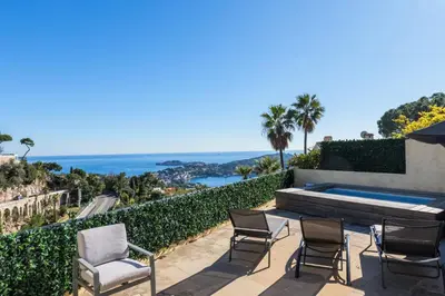 a patio with chairs and a swimming pool at Elegance, serenite et vue exeptionnelle sur la rade in Villefranche-sur-Mer