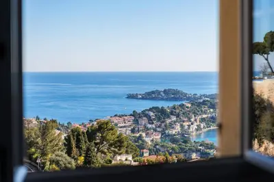 a view of the ocean from a window at Elegance, serenite et vue exeptionnelle sur la rade in Villefranche-sur-Mer