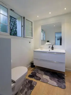 a bathroom with a toilet and a sink and a mirror at Elegance, serenite et vue exeptionnelle sur la rade in Villefranche-sur-Mer