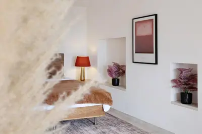 a bedroom with a bed with a lamp and flowers at Elegance, serenite et vue exeptionnelle sur la rade in Villefranche-sur-Mer